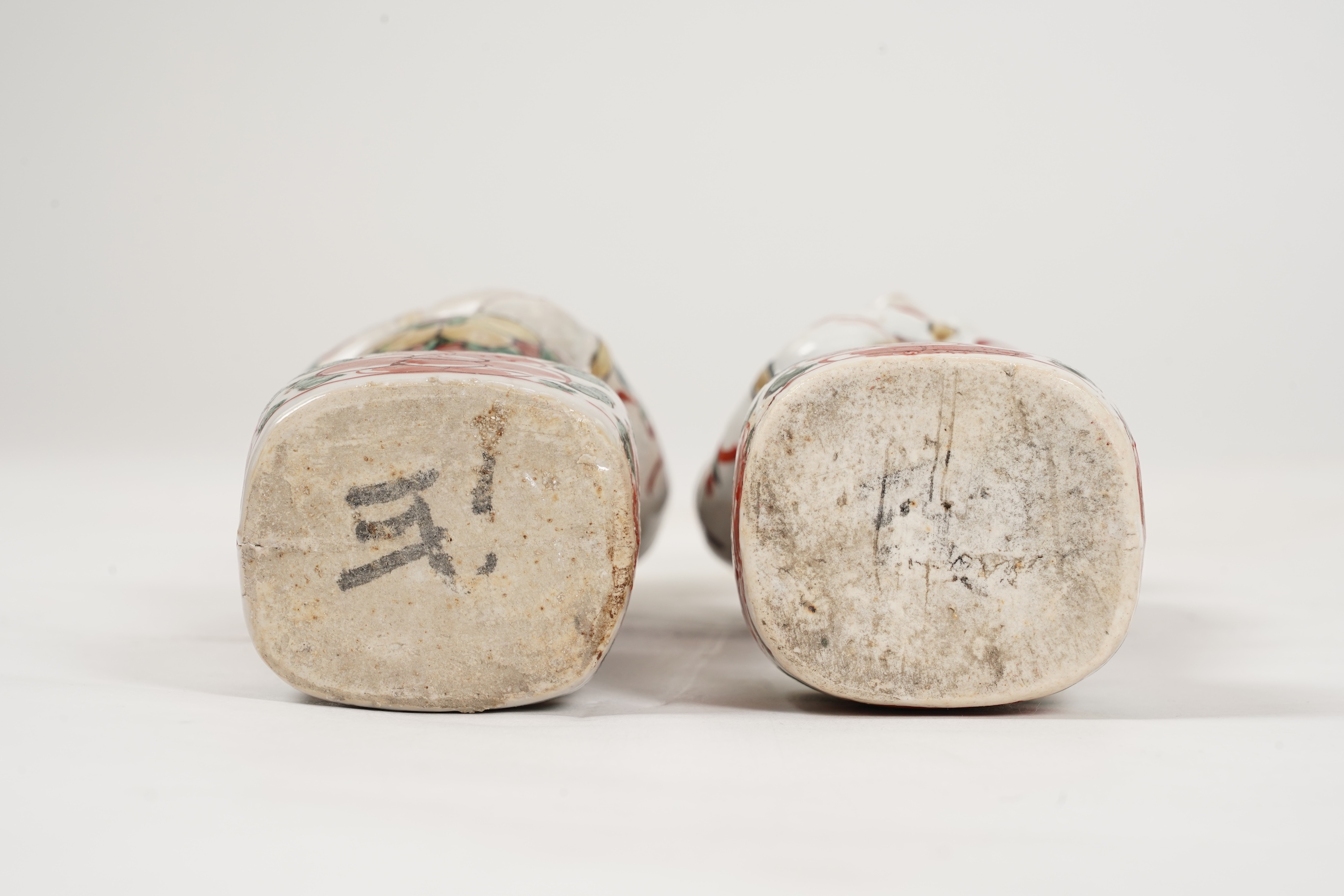 A pair of Chinese famille verte figures of smiling boys, Kangxi period